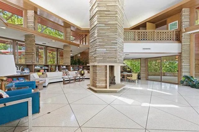 a view of a patio with dining table and chairs with a barbeque