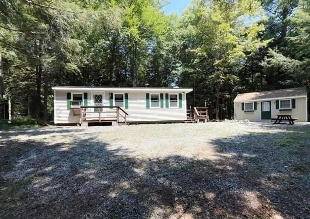 a view of a house with backyard and sitting area