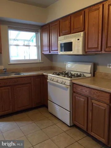 a kitchen with stainless steel appliances granite countertop a sink stove and microwave