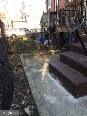 a view of a yard with wooden fence
