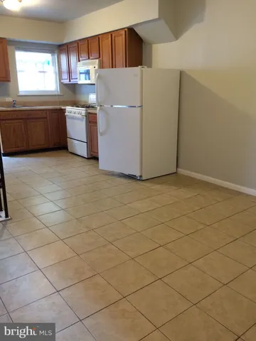 a kitchen with stainless steel appliances a cabinets and a window
