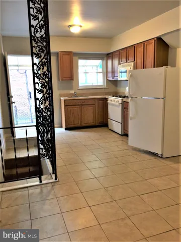 a kitchen with a sink a refrigerator and window