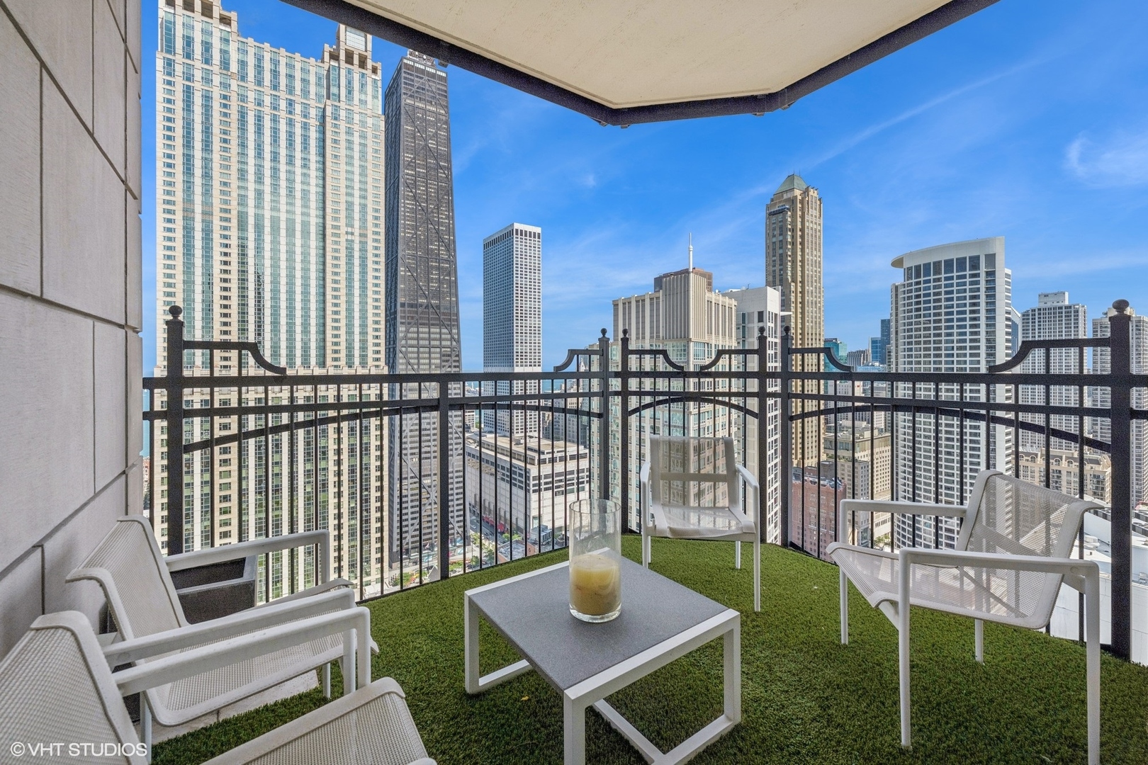 11 East Walton Street, Unit 4101 Chicago, IL 60611 - Photo 13 of 45 a view of a balcony with two chairs and a table