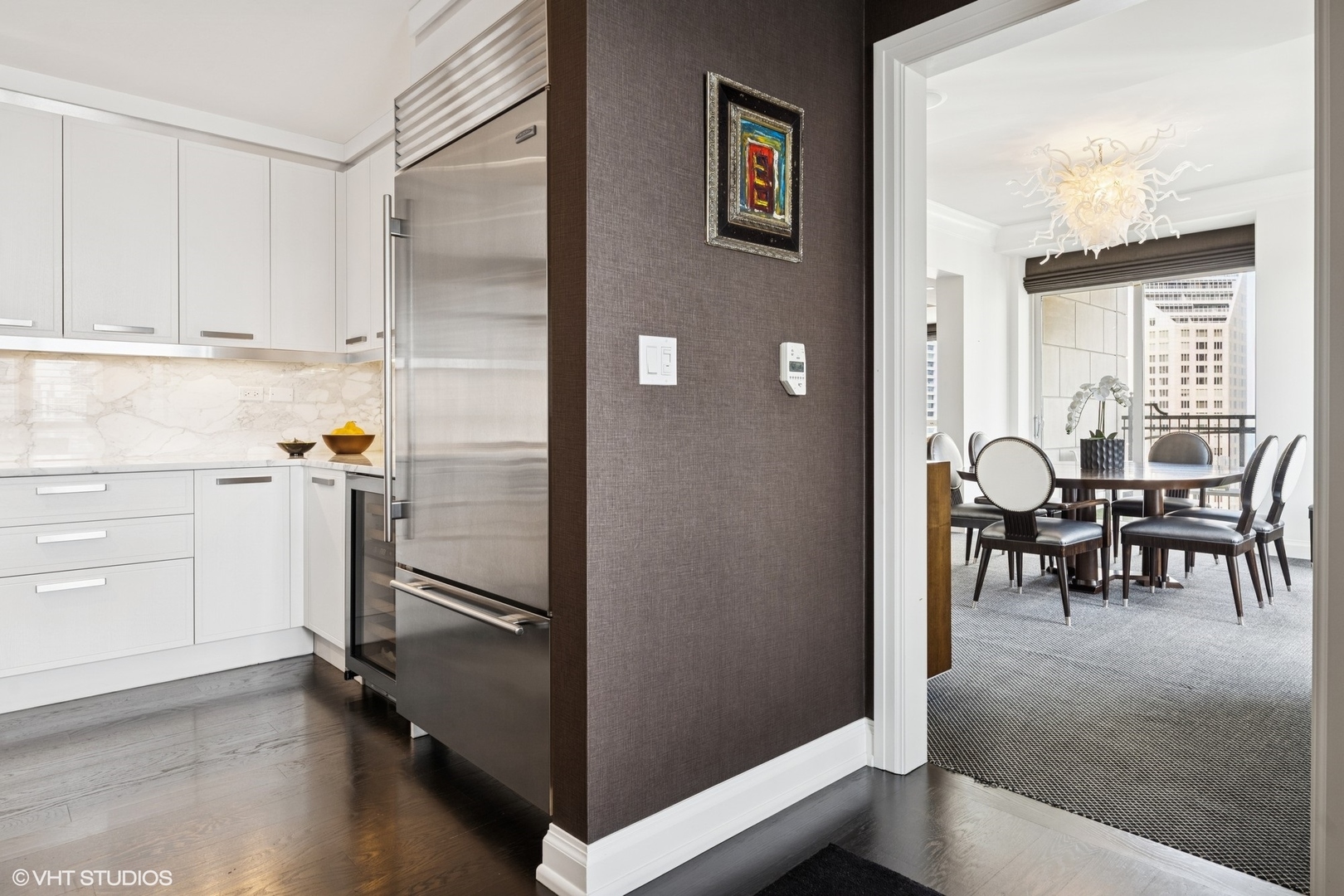11 East Walton Street, Unit 4101 Chicago, IL 60611 - Photo 15 of 45 a kitchen with stainless steel appliances granite countertop a refrigerator and cabinets