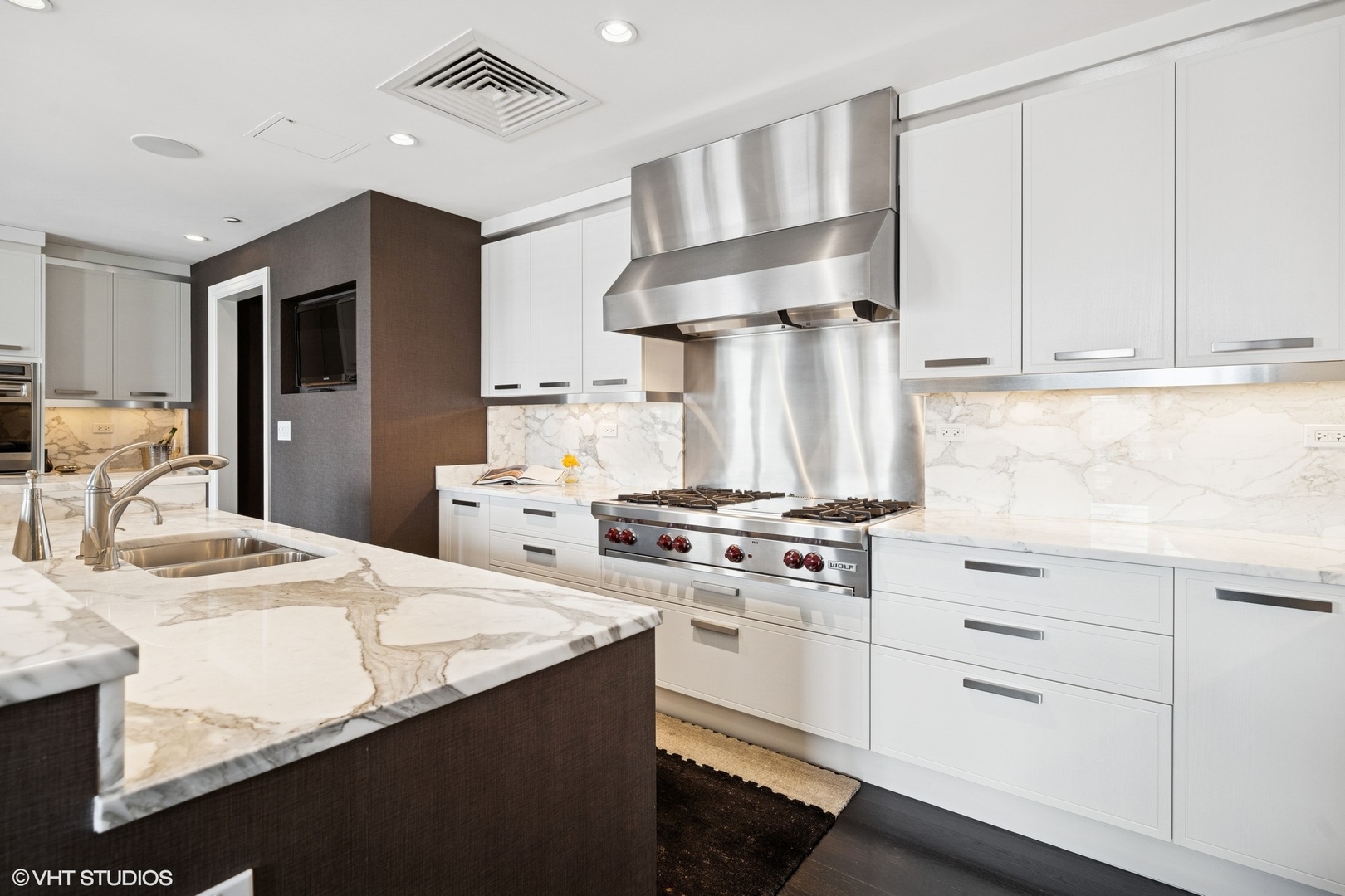 11 East Walton Street, Unit 4101 Chicago, IL 60611 - Photo 16 of 45 a kitchen with a stove a sink and a refrigerator