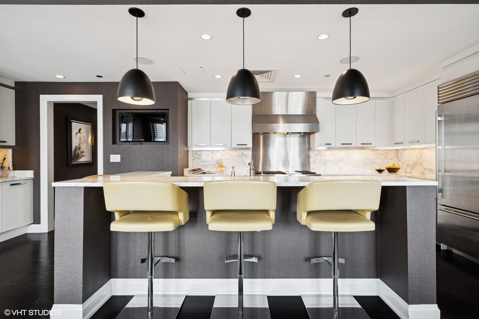 11 East Walton Street, Unit 4101 Chicago, IL 60611 - Photo 20 of 45 a kitchen with cabinets and chairs