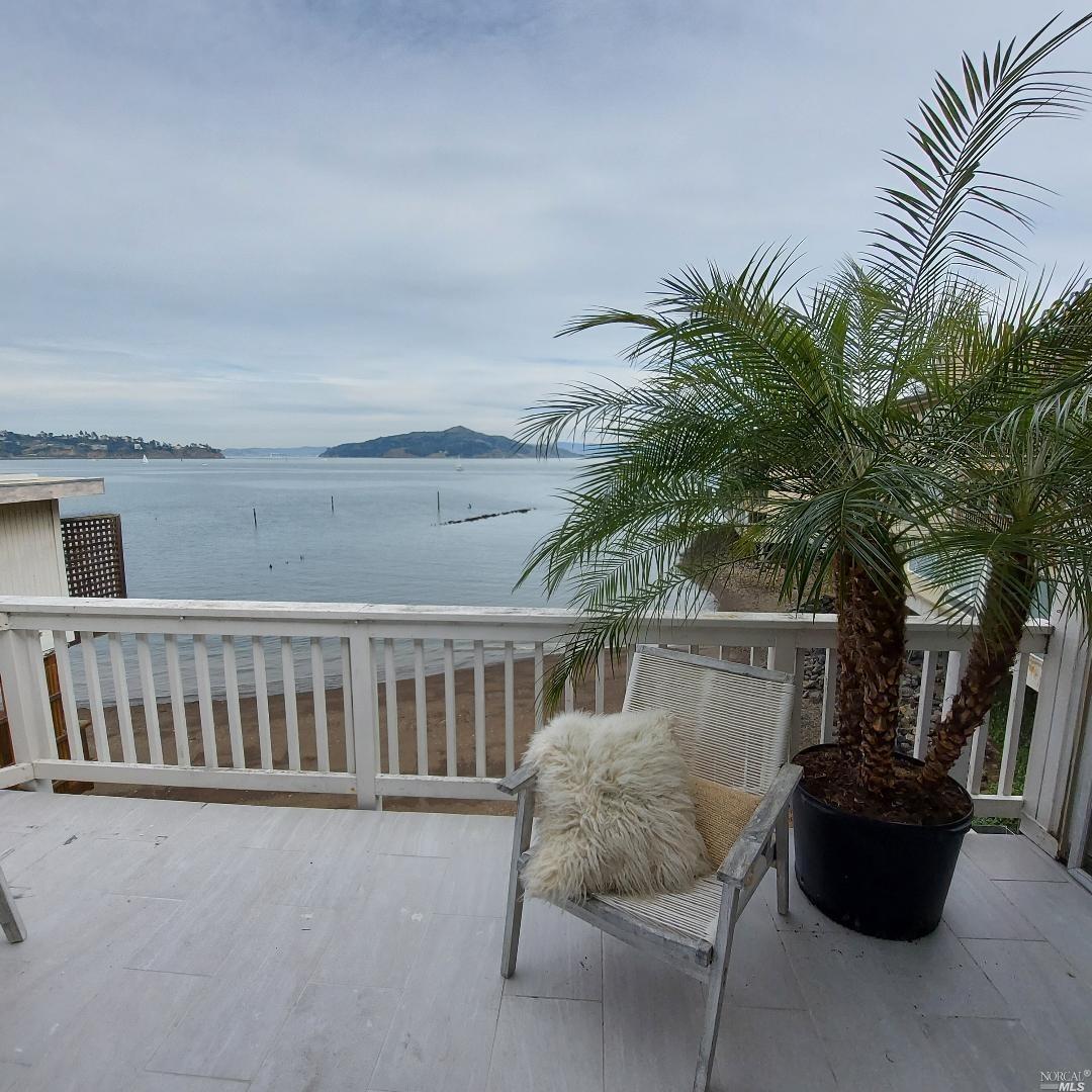 a view of balcony with furniture and potted plants