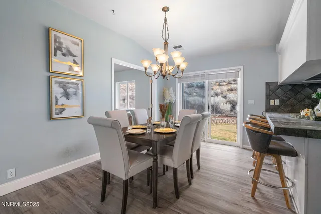 a dining room with furniture a window and wooden floor