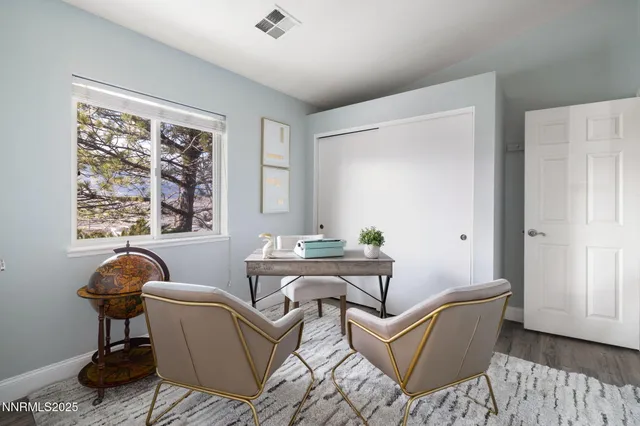 a living room with furniture a window and a potted plant