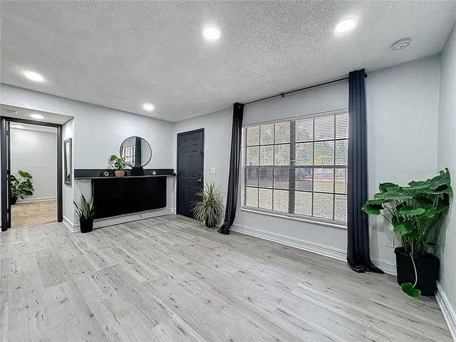 an empty room with windows and closet