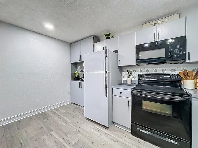 a view of a room with furniture and a mirror