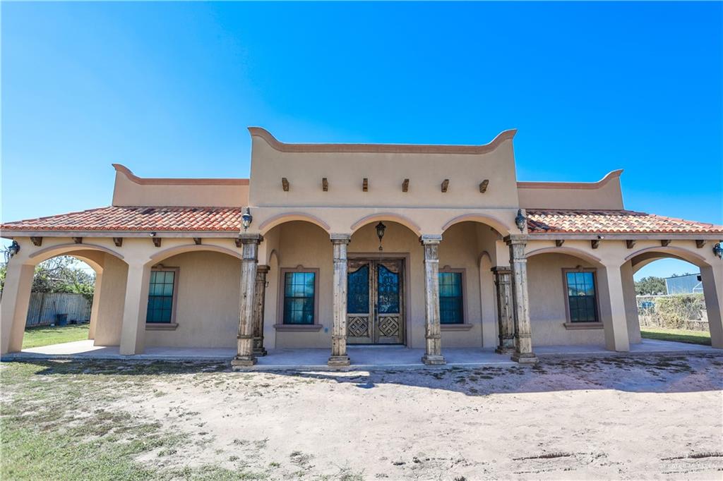 825 Carpintero Street Edinburg, TX 78542 - Photo 1 of 1 a view of a white house with large windows