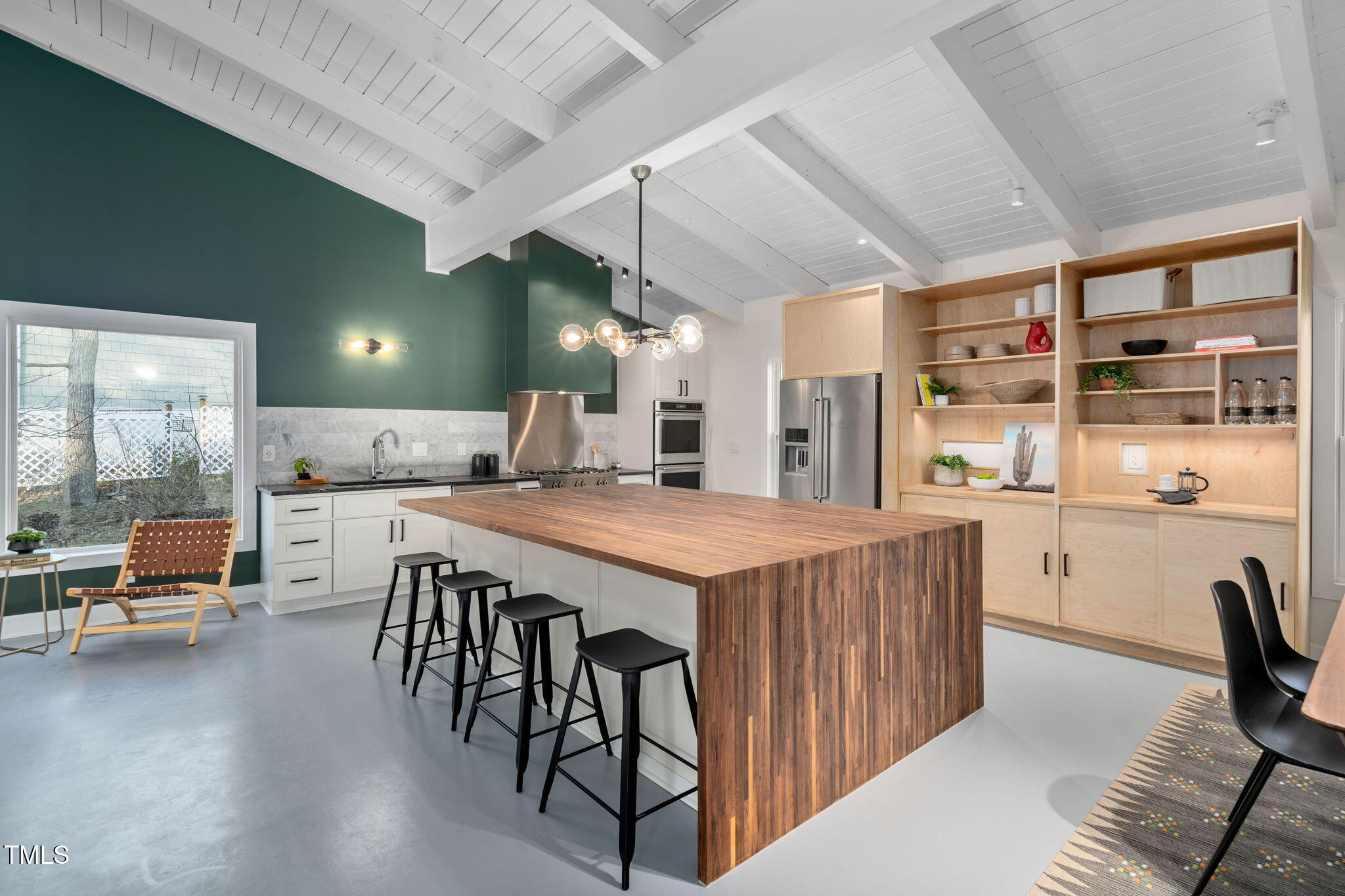 110 Continental Drive Durham, NC 27712 - Photo 14 of 51 a kitchen with stainless steel appliances kitchen island granite countertop a table chairs in it and wooden floors