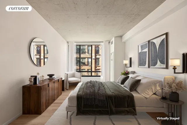 a spacious bedroom with a bed a mirror and a large window