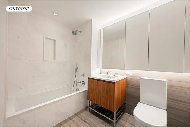 a bathroom with a sink a toilet and bathtub