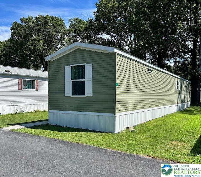 8220 Airport Road, Unit TRLR 17 Bath, PA 18014 - Photo 4 of 25 a front view of a house with a yard and garage