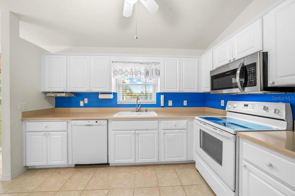 6145 Southwest 100th Loop Ocala, FL 34476 - Photo 17 of 54 a kitchen with stainless steel appliances granite countertop a sink and cabinets