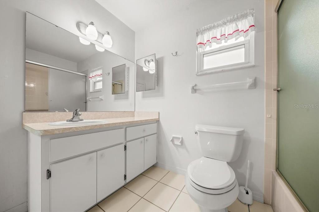 6145 Southwest 100th Loop Ocala, FL 34476 - Photo 26 of 54 a bathroom with a toilet sink and mirror