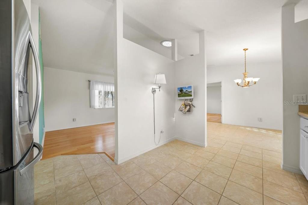 6145 Southwest 100th Loop Ocala, FL 34476 - Photo 30 of 54 an empty room with kitchen and entrance