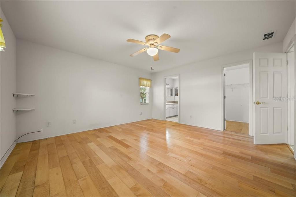 6145 Southwest 100th Loop Ocala, FL 34476 - Photo 32 of 54 a view of empty room with wooden floor and ceiling fan