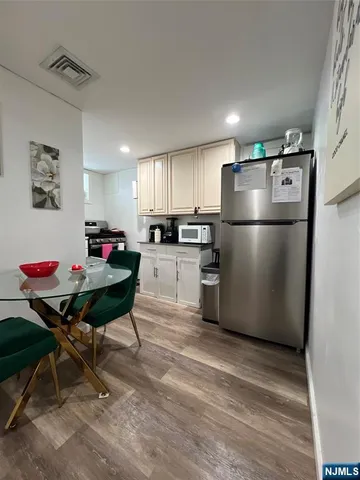 a view of a house with entryway and wooden floor