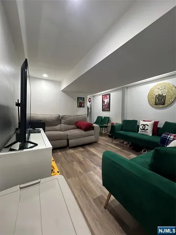 an empty room with wooden floor and a window