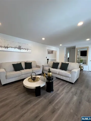a open kitchen with kitchen island white cabinets and stainless steel appliances