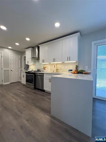 a kitchen with stainless steel appliances a refrigerator sink and cabinets