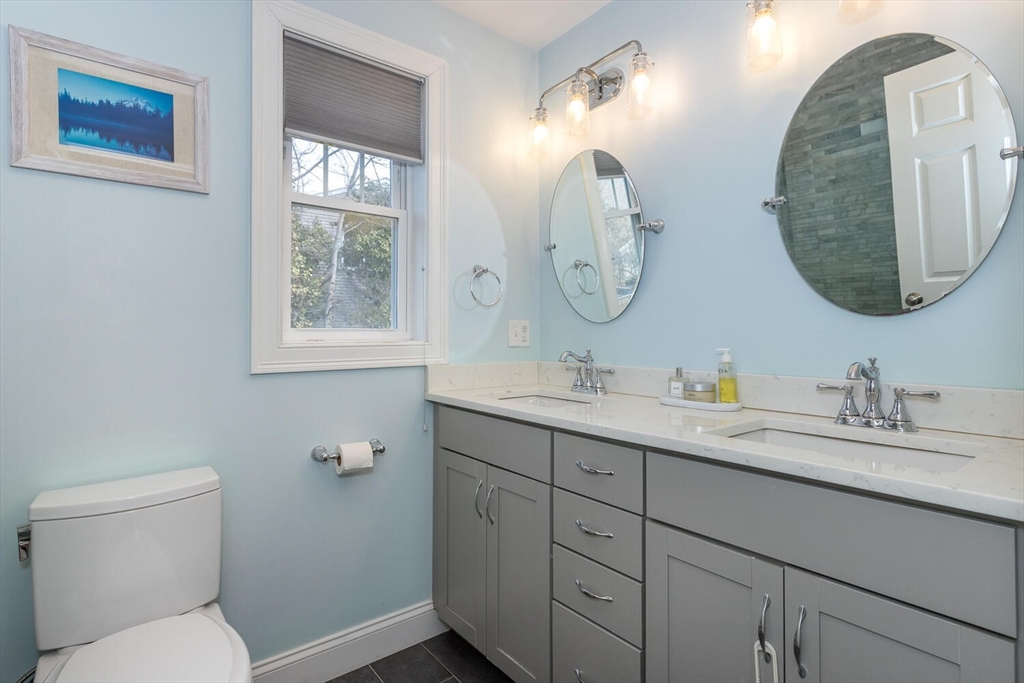 59 Endicott Street, Unit 59 Canton, MA 02021 - Photo 13 of 20 a bathroom with a toilet sink and mirror