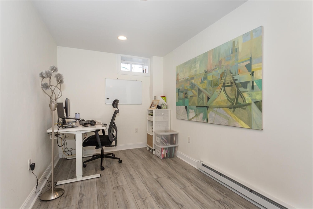 59 Endicott Street, Unit 59 Canton, MA 02021 - Photo 17 of 20 a view of a workspace with furniture and wooden floor