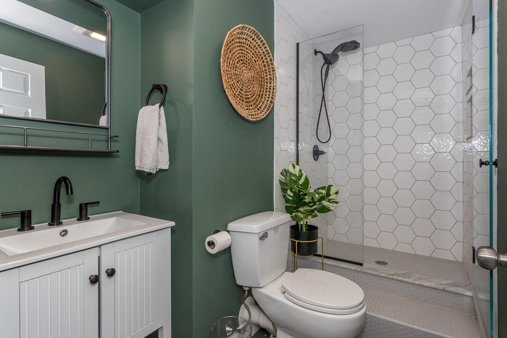 59 Endicott Street, Unit 59 Canton, MA 02021 - Photo 18 of 20 a bathroom with a toilet sink and mirror