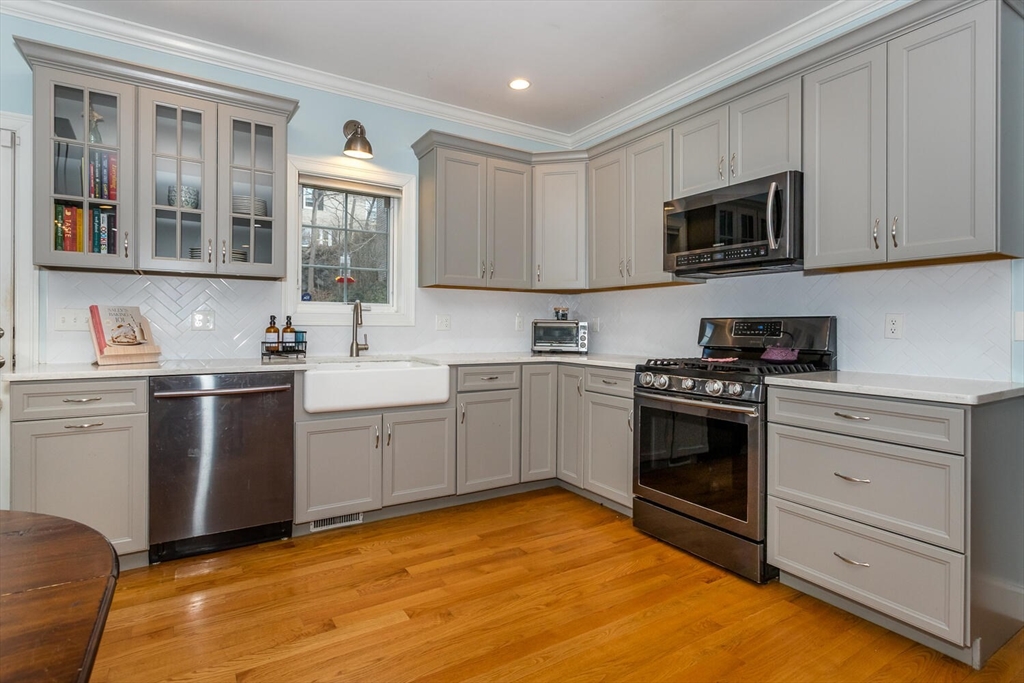 59 Endicott Street, Unit 59 Canton, MA 02021 - Photo 7 of 20 a kitchen with stainless steel appliances granite countertop a stove a sink and a refrigerator