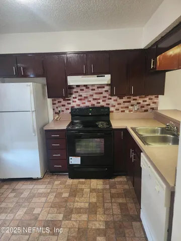 a view of an empty room with a fireplace