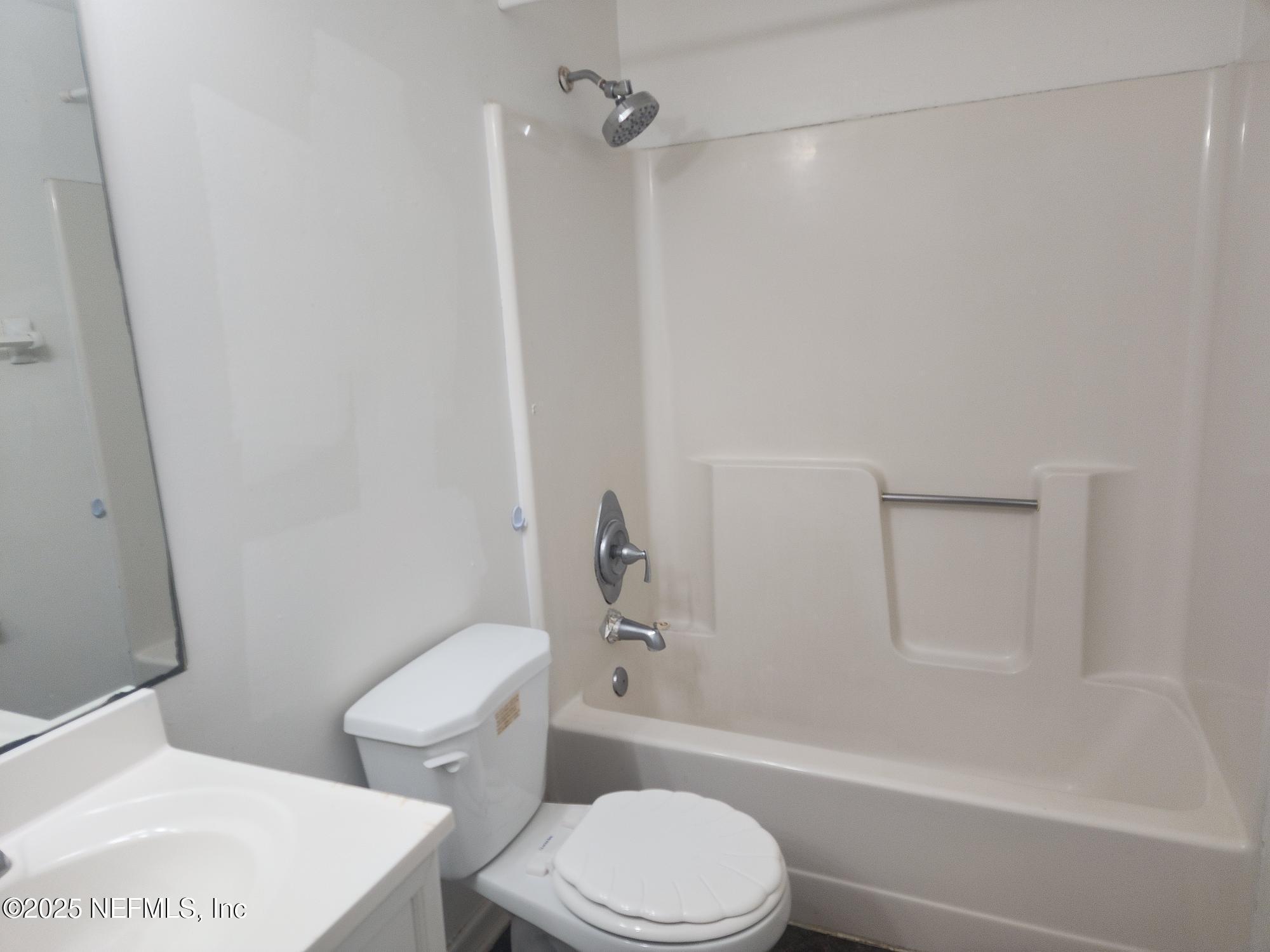 4641 Barnes Road South Jacksonville, FL 32207 - Photo 7 of 12 a white toilet sitting next to a bath tub