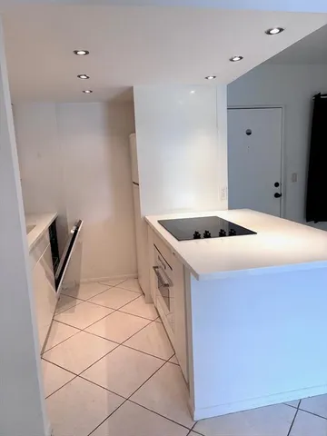 a kitchen with a sink and a refrigerator