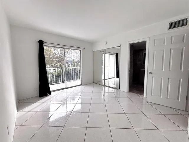 a view of an empty room with glass door