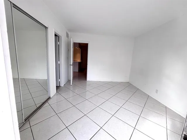 a view of an empty room with glass door