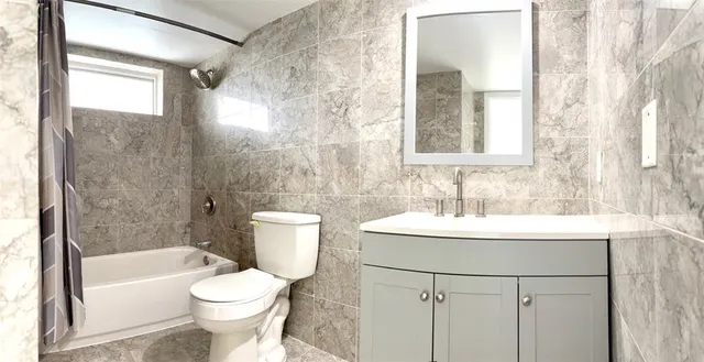 a bathroom with a sink toilet a mirror and shower