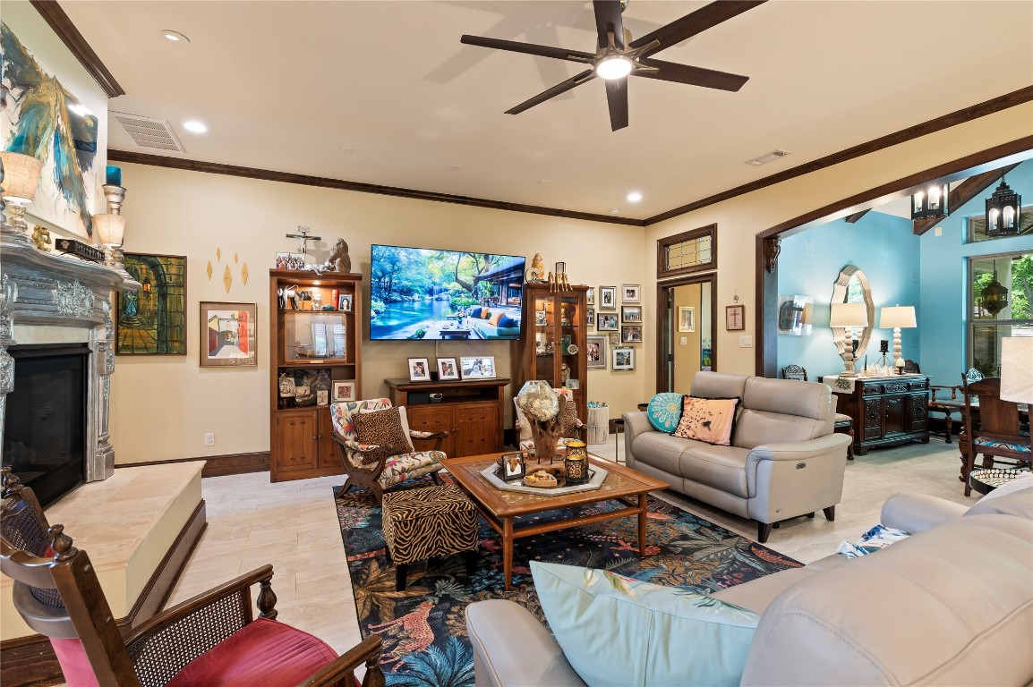2201 Water Way Seabrook, TX 77586 - Photo 12 of 48 This inviting living room features a cozy fireplace, and the room flows into a bright dining area with a vibrant blue accent wall, creating a warm and welcoming space perfect for entertaining.