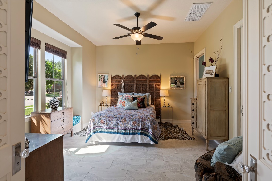 2201 Water Way Seabrook, TX 77586 - Photo 15 of 48 This guest bedroom suite is cozy and inviting, featuring custom doors with special details and ample natural light from two sizable windows. It includes an en-suite bathroom and large Walkin closet.