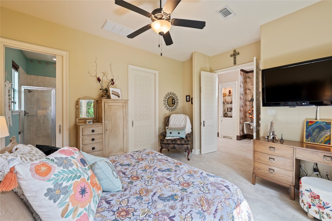 2201 Water Way Seabrook, TX 77586 - Photo 16 of 48 This cozy bedroom offers an en-suite bathroom with a shower, ample storage. The room is well-lit and has a warm, inviting atmosphere.
