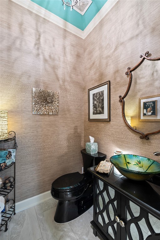 2201 Water Way Seabrook, TX 77586 - Photo 27 of 48 This is a stylish powder room featuring textured walls, a unique black toilet, and a decorative vanity with a colorful vessel sink. The space is accented with a distinctive mirror, creating a sophisticated and inviting atmosphere.