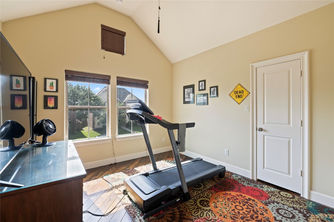 2201 Water Way Seabrook, TX 77586 - Photo 29 of 48 Bright, cozy secondary upstairs bedroom with vaulted ceiling, featuring a large windows overlooking the front of the home. Ideal for a bedroom, home gym or relaxation space.