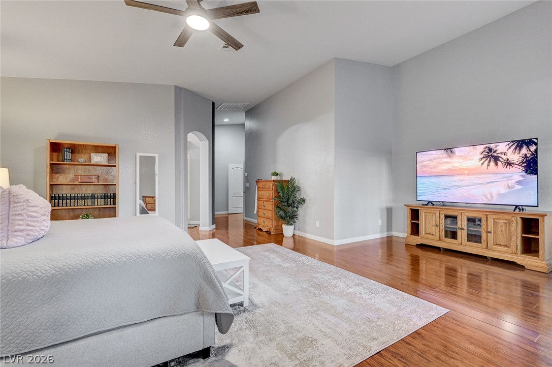 1604 Cattle Ranch Place Henderson, NV 89002 - Photo 36 of 99 Hardwood flooring extends throughout this generous bedroom, providing a warm and inviting atmosphere.