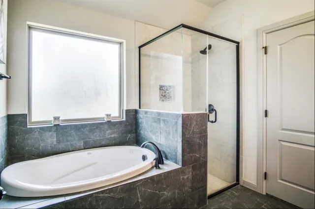 a bath tub sitting in a bathroom next to a window