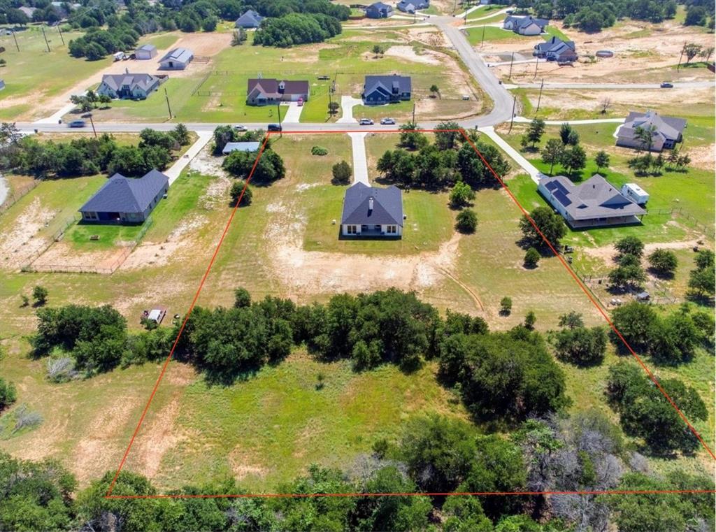116 Grey Hound Lane Poolville, TX 76487 - Photo 2 of 16 an aerial view of residential houses with outdoor space and swimming pool