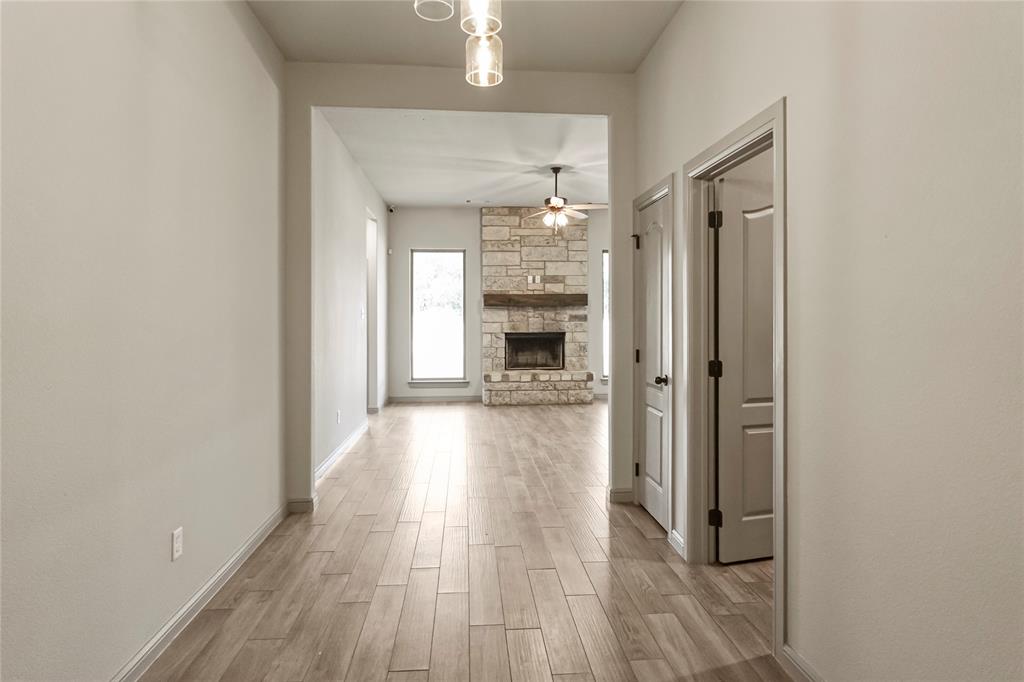 116 Grey Hound Lane Poolville, TX 76487 - Photo 5 of 16 wooden floor in a gallery with a mirror