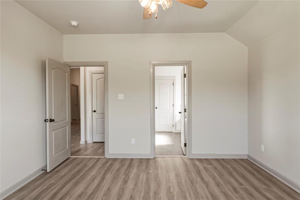 116 Grey Hound Lane Poolville, TX 76487 - Photo 8 of 16 wooden floor in an empty room with a window