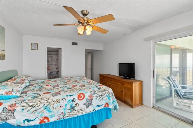 a bedroom with furniture and a floor to ceiling window