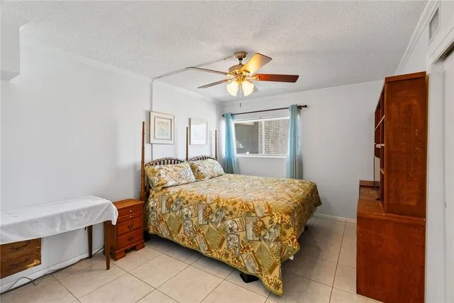 a bedroom with a bed and a television